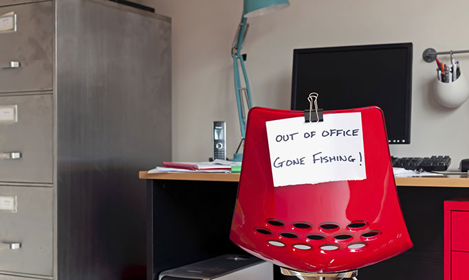 Out of office sign on work chair because employee knows the benefits of vacation